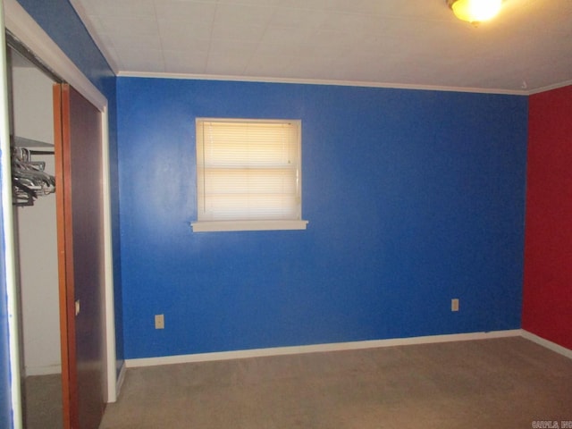 unfurnished bedroom with carpet flooring, baseboards, and a closet