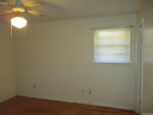 unfurnished room featuring wood finished floors, baseboards, and ceiling fan