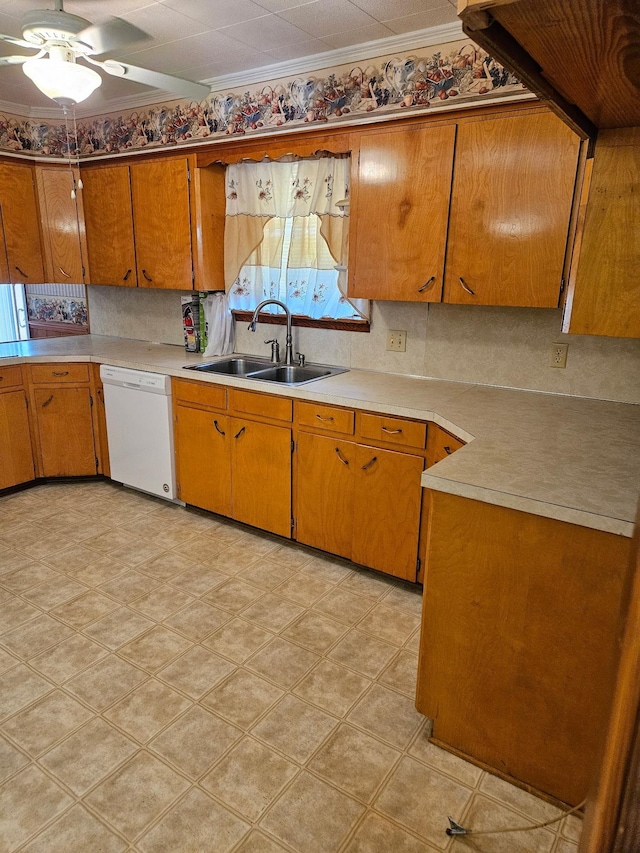 kitchen featuring light countertops, a ceiling fan, white dishwasher, and a sink