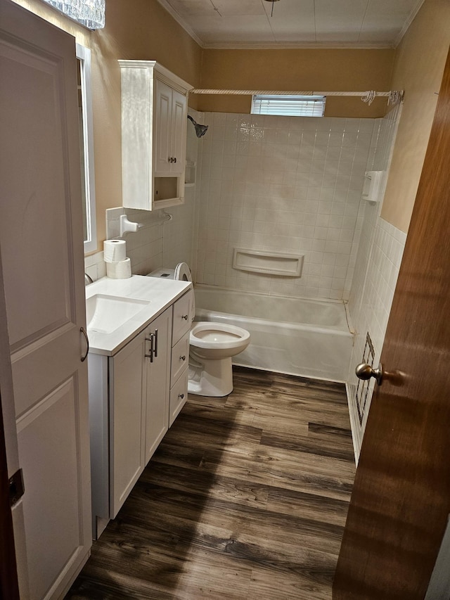 full bath featuring vanity, crown molding, wood finished floors, and shower / bath combination