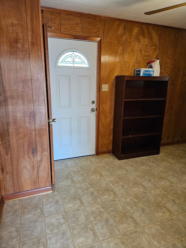 entryway featuring wooden walls