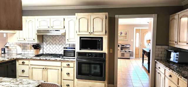 kitchen with light stone counters, tasteful backsplash, light tile patterned floors, ornamental molding, and black appliances