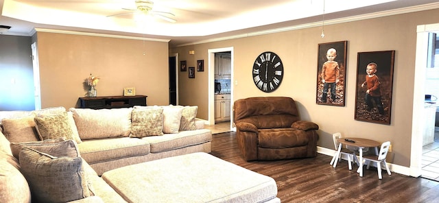 living room with ornamental molding, dark hardwood / wood-style floors, and ceiling fan