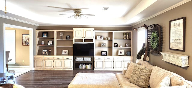 living room with a raised ceiling, ornamental molding, dark hardwood / wood-style floors, and ceiling fan