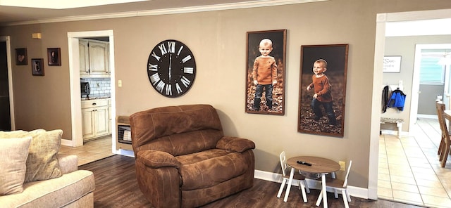 living room featuring ornamental molding and tile patterned flooring