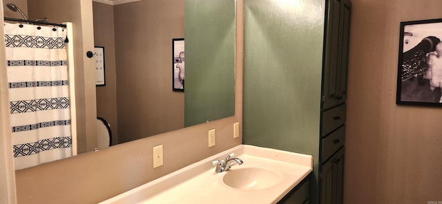 bathroom featuring crown molding and vanity