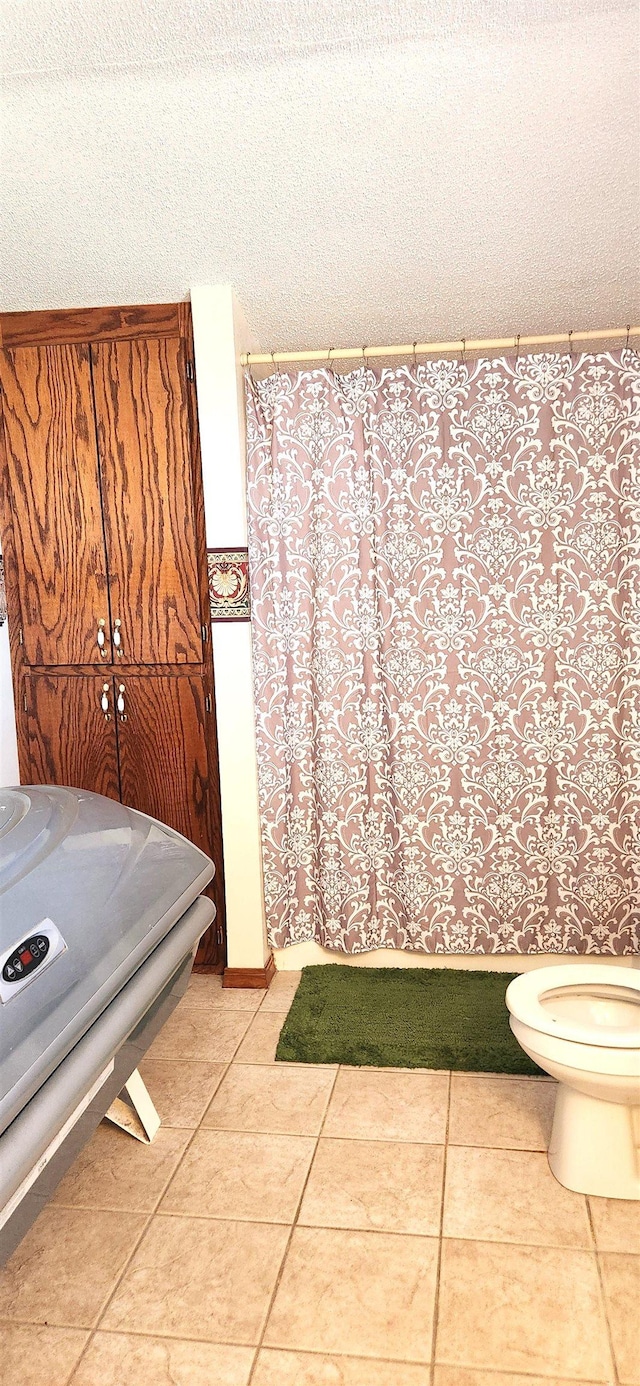 bathroom with tile patterned floors and toilet