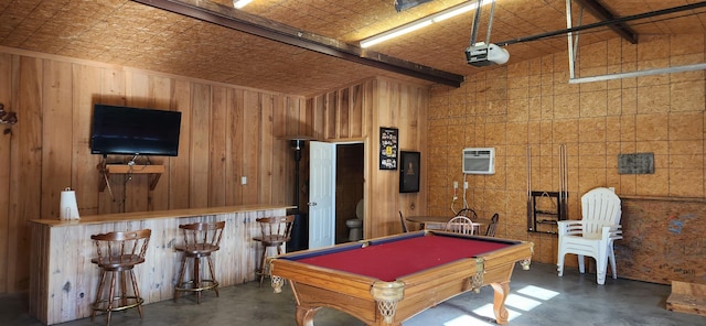 recreation room featuring a wall mounted air conditioner, bar area, pool table, beamed ceiling, and wood walls