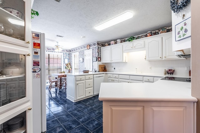 kitchen featuring white cabinetry, white dishwasher, black electric stovetop, a textured ceiling, and kitchen peninsula