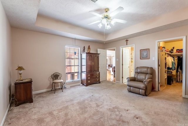 living area featuring light colored carpet and a textured ceiling