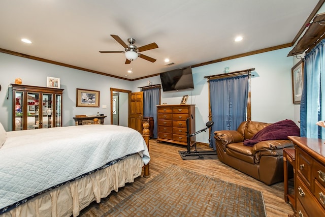 bedroom featuring crown molding, ceiling fan, and light hardwood / wood-style flooring