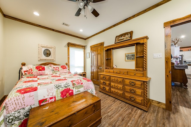 bedroom featuring wood-type flooring, ornamental molding, and ceiling fan