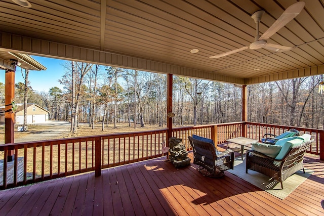 wooden terrace with ceiling fan and outdoor lounge area