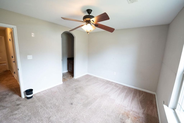 carpeted spare room with ceiling fan