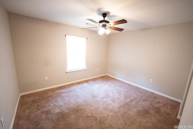 spare room featuring carpet floors and ceiling fan