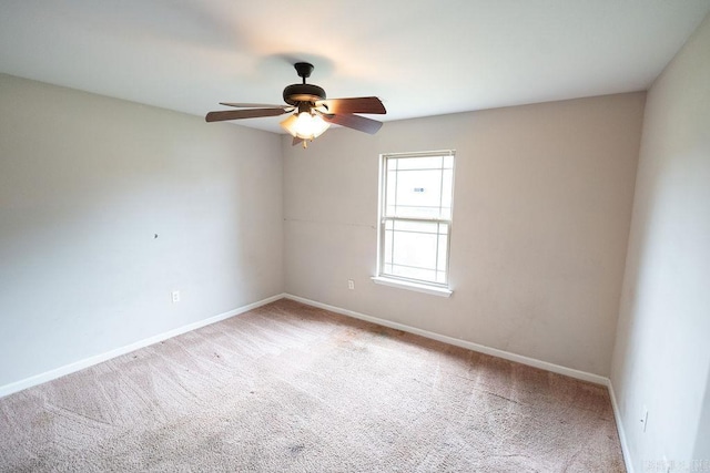 spare room featuring carpet flooring and ceiling fan