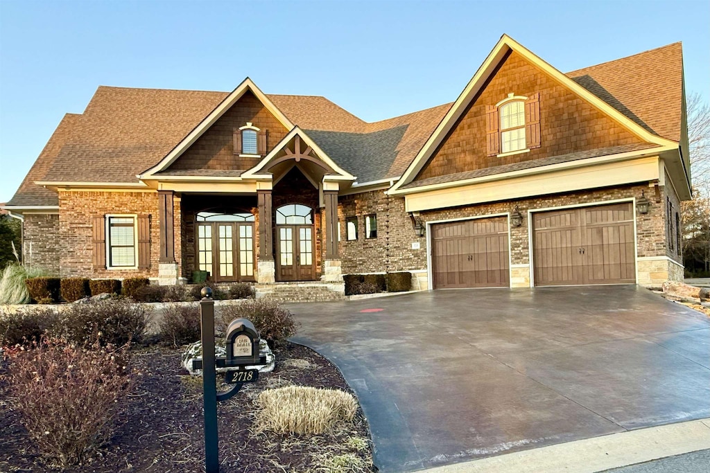 craftsman house featuring french doors and a garage