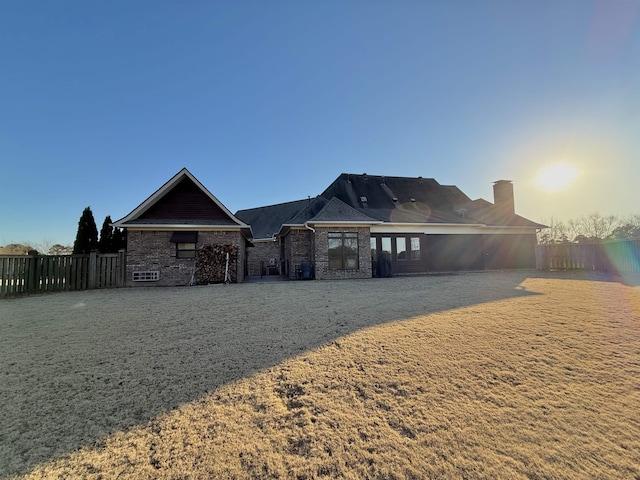 back house at dusk featuring a yard