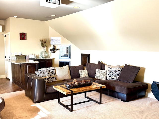 carpeted living room featuring lofted ceiling