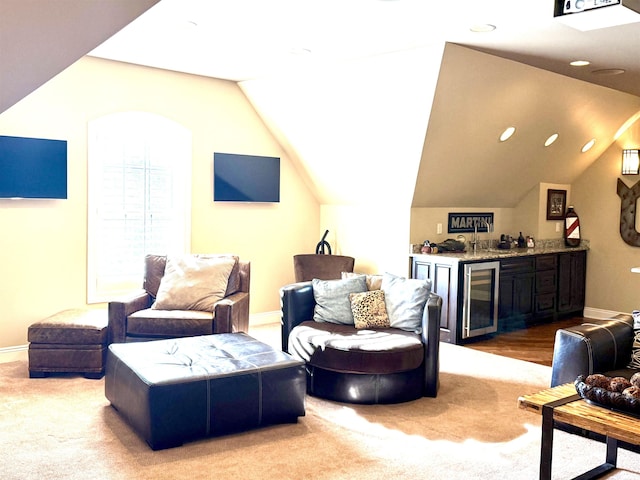 carpeted living room featuring wine cooler, lofted ceiling, and bar area