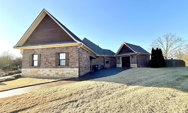 view of property exterior with a garage and a yard