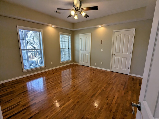 interior space with ceiling fan and dark hardwood / wood-style floors