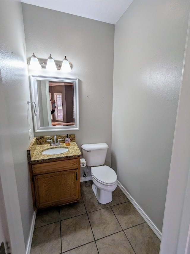 bathroom featuring vanity, tile patterned floors, and toilet