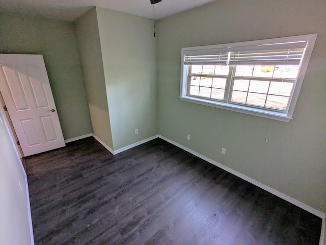 spare room with dark hardwood / wood-style floors