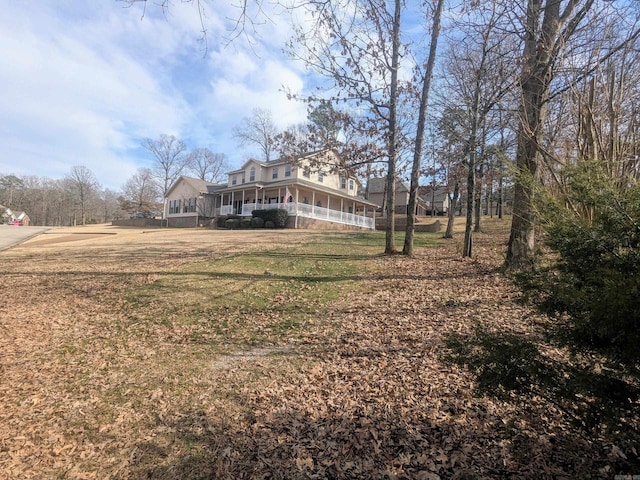 view of yard with a sunroom and covered porch