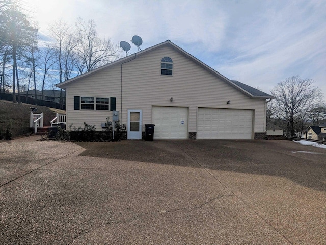 back of property featuring a garage