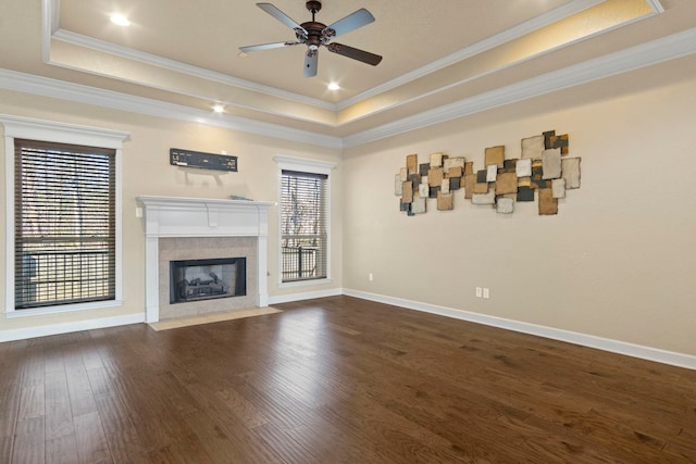 unfurnished living room featuring a healthy amount of sunlight, a fireplace, and a raised ceiling