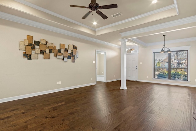 unfurnished living room with decorative columns, crown molding, dark hardwood / wood-style flooring, and a tray ceiling