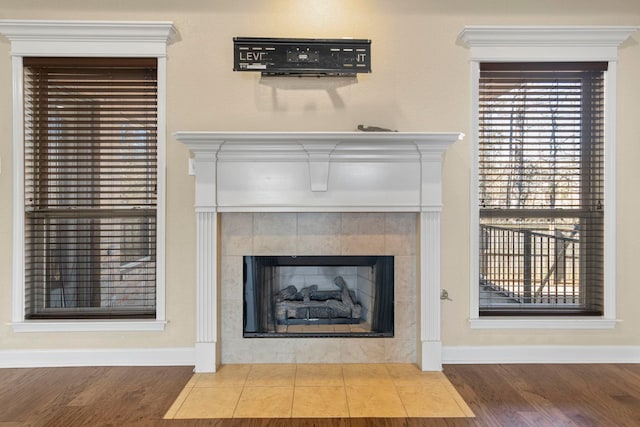 details with hardwood / wood-style flooring and a fireplace