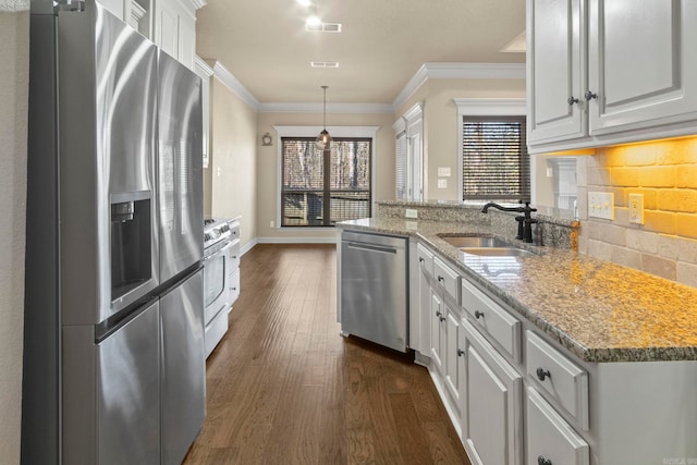 kitchen with white cabinetry, sink, decorative light fixtures, and stainless steel appliances