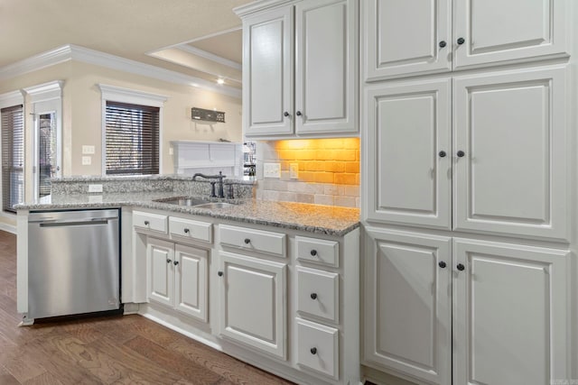 kitchen featuring sink, dishwasher, white cabinetry, light stone counters, and decorative backsplash