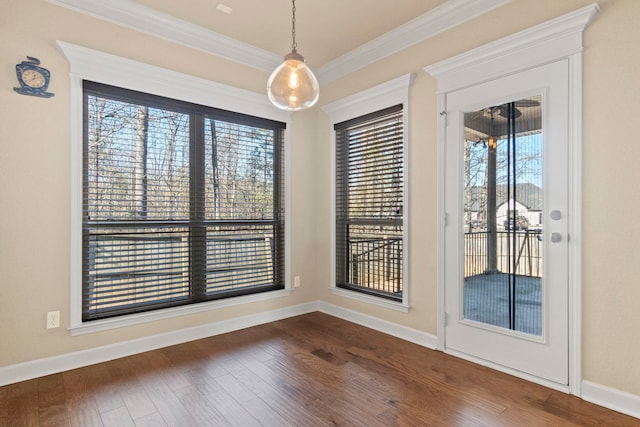 spare room with ornamental molding and dark hardwood / wood-style floors