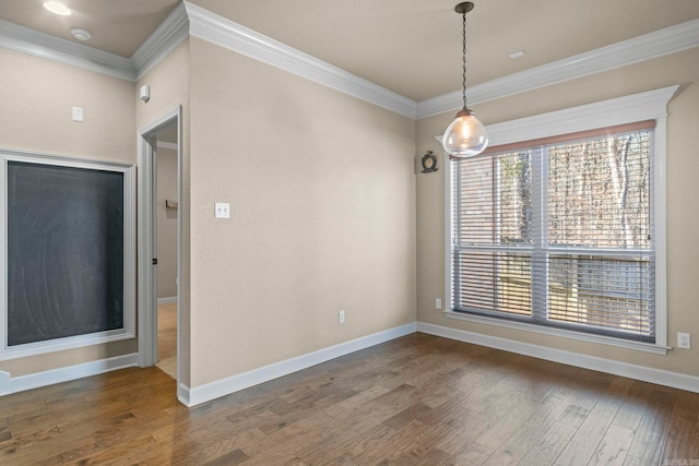 spare room featuring dark hardwood / wood-style flooring and crown molding