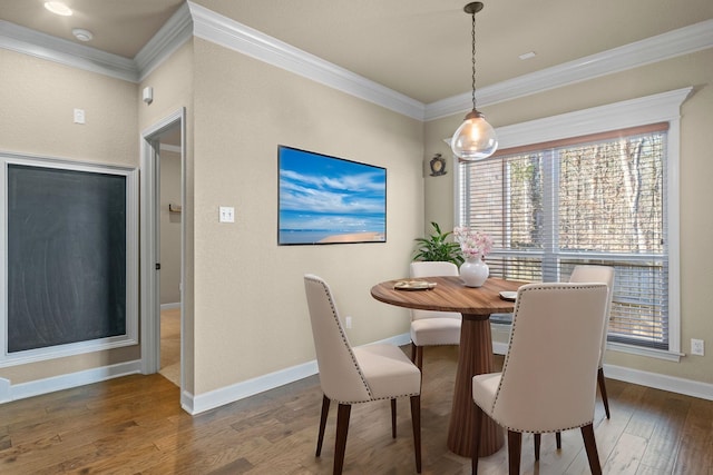 dining area featuring crown molding and dark hardwood / wood-style floors