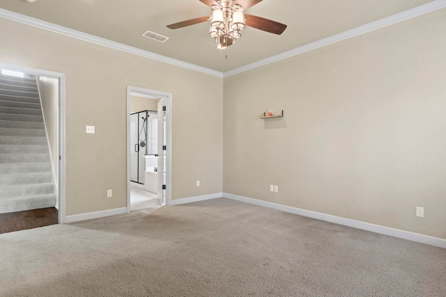 empty room featuring crown molding, light colored carpet, and ceiling fan