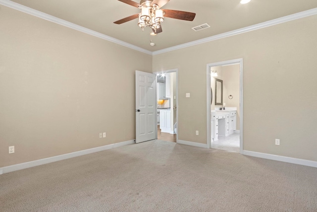 unfurnished bedroom featuring ensuite bathroom, crown molding, light carpet, and ceiling fan