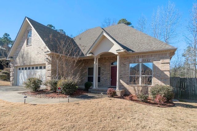 view of front of property featuring a garage and a front lawn