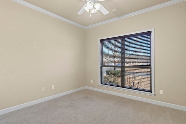 spare room with ornamental molding, carpet flooring, and ceiling fan