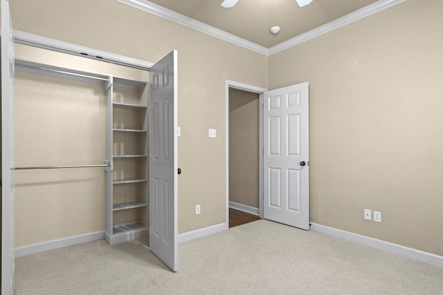 unfurnished bedroom with ornamental molding, ceiling fan, and carpet flooring