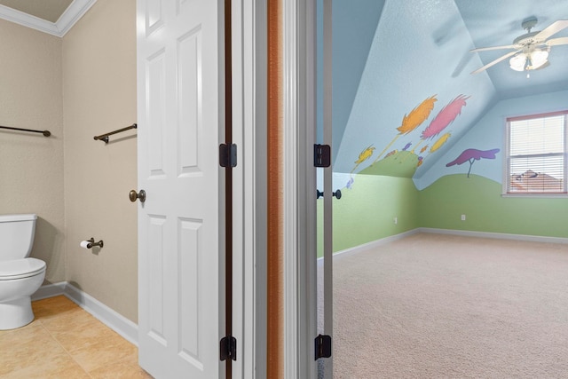 bathroom featuring lofted ceiling, ceiling fan, crown molding, and toilet