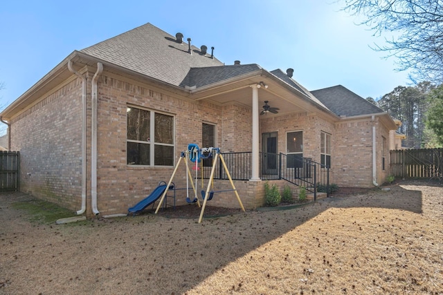 back of house featuring a playground and ceiling fan