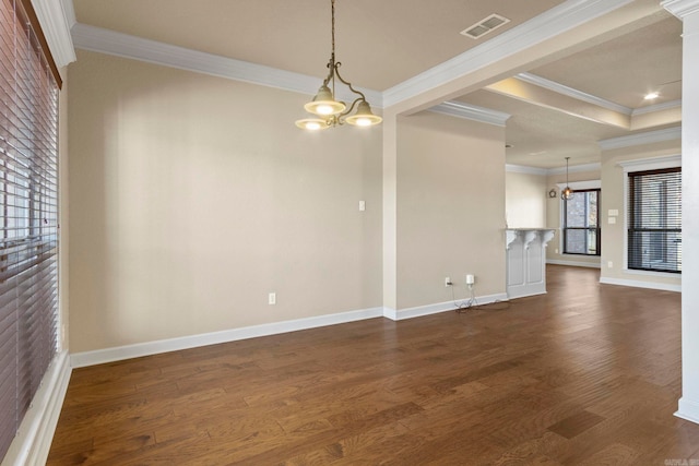 unfurnished room with a tray ceiling, a notable chandelier, crown molding, and dark wood-type flooring