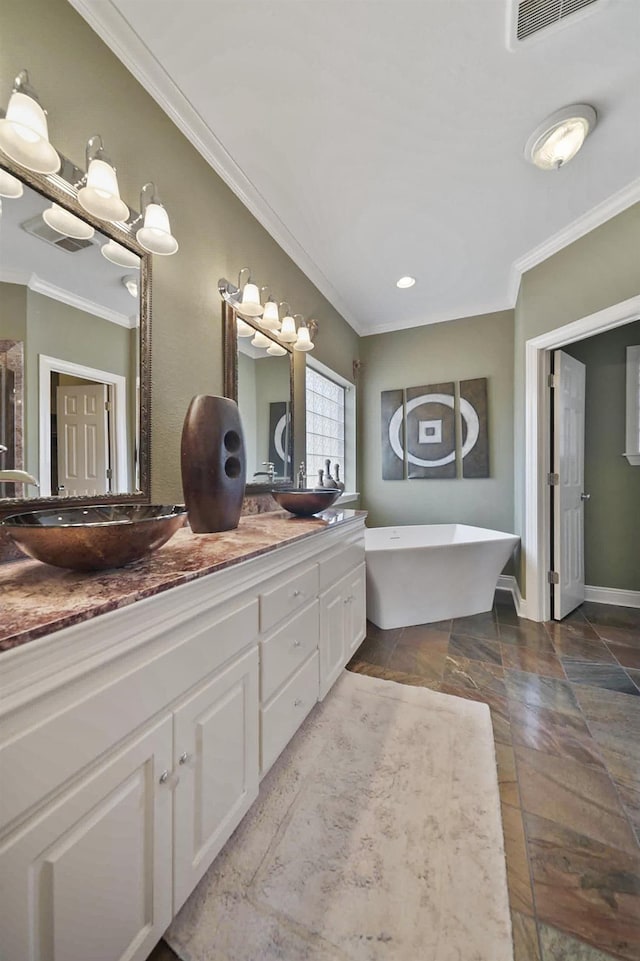 bathroom with vanity, a bath, and crown molding