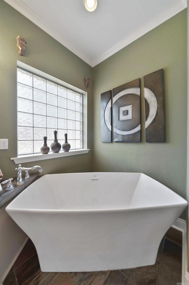 bathroom featuring crown molding and a tub to relax in