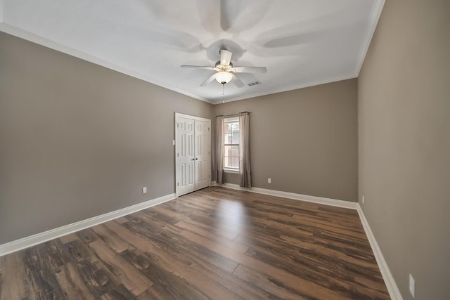 empty room featuring crown molding, dark hardwood / wood-style floors, and ceiling fan