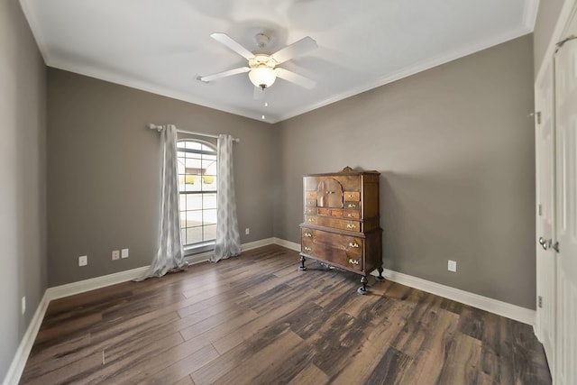 spare room with crown molding, dark hardwood / wood-style floors, and ceiling fan